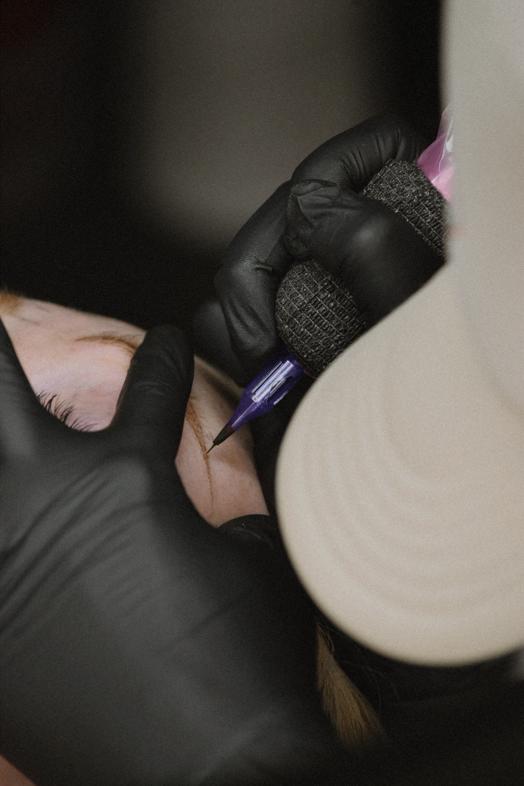 Nano brow strokes being tattooed with a cosmetic machine